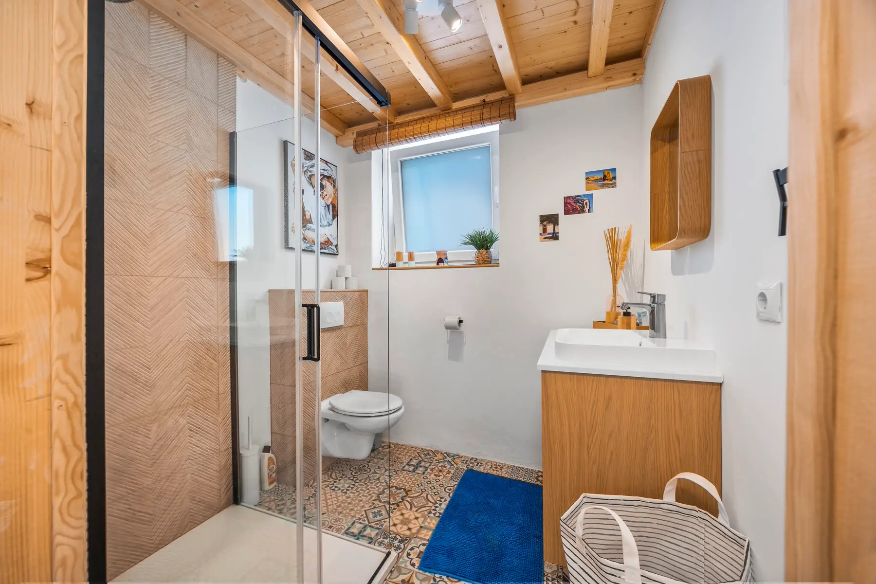 The bathroom with its walk-in shower, basin and toilet.