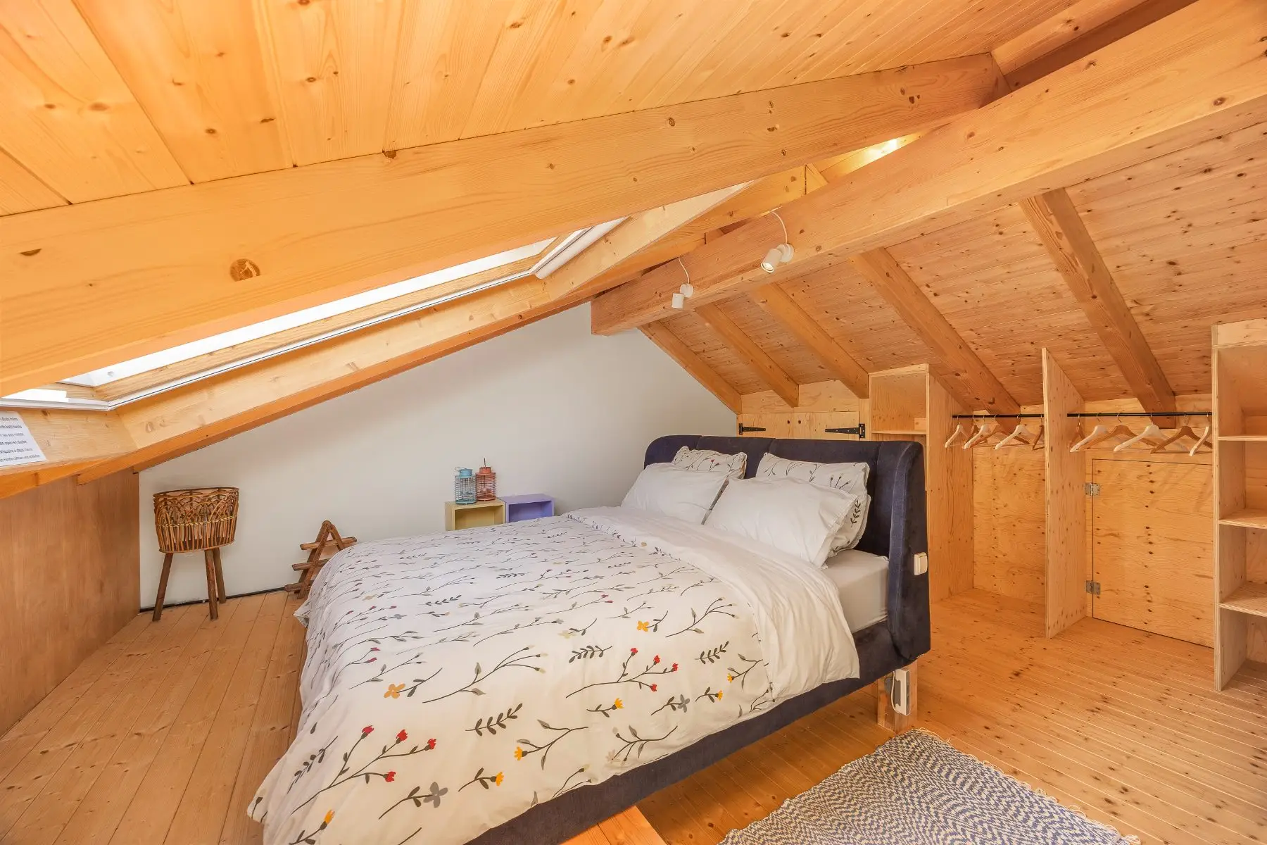The double bed under the large skylight, with plenty of space for clothes