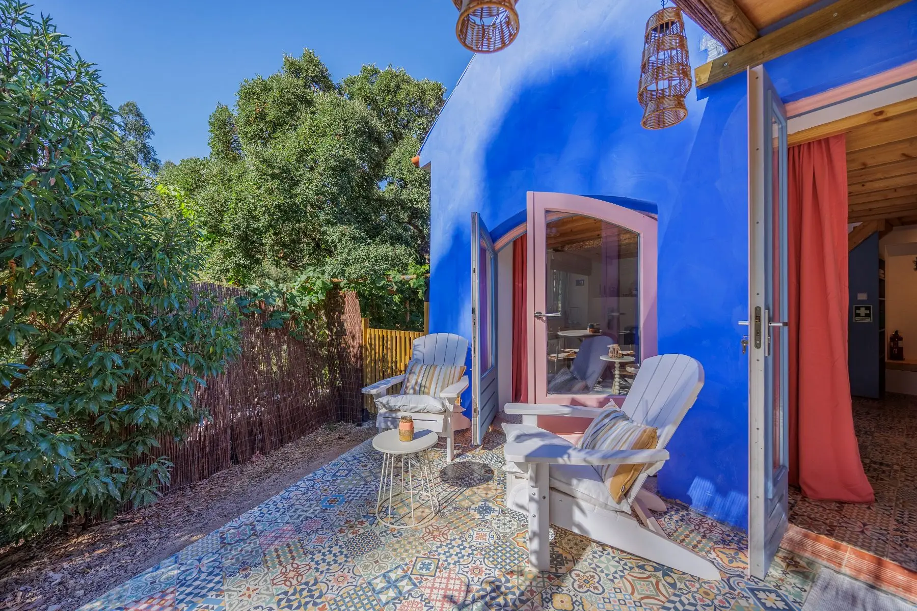 Two comfortable chairs on the terrace, on the patterned tiles.
