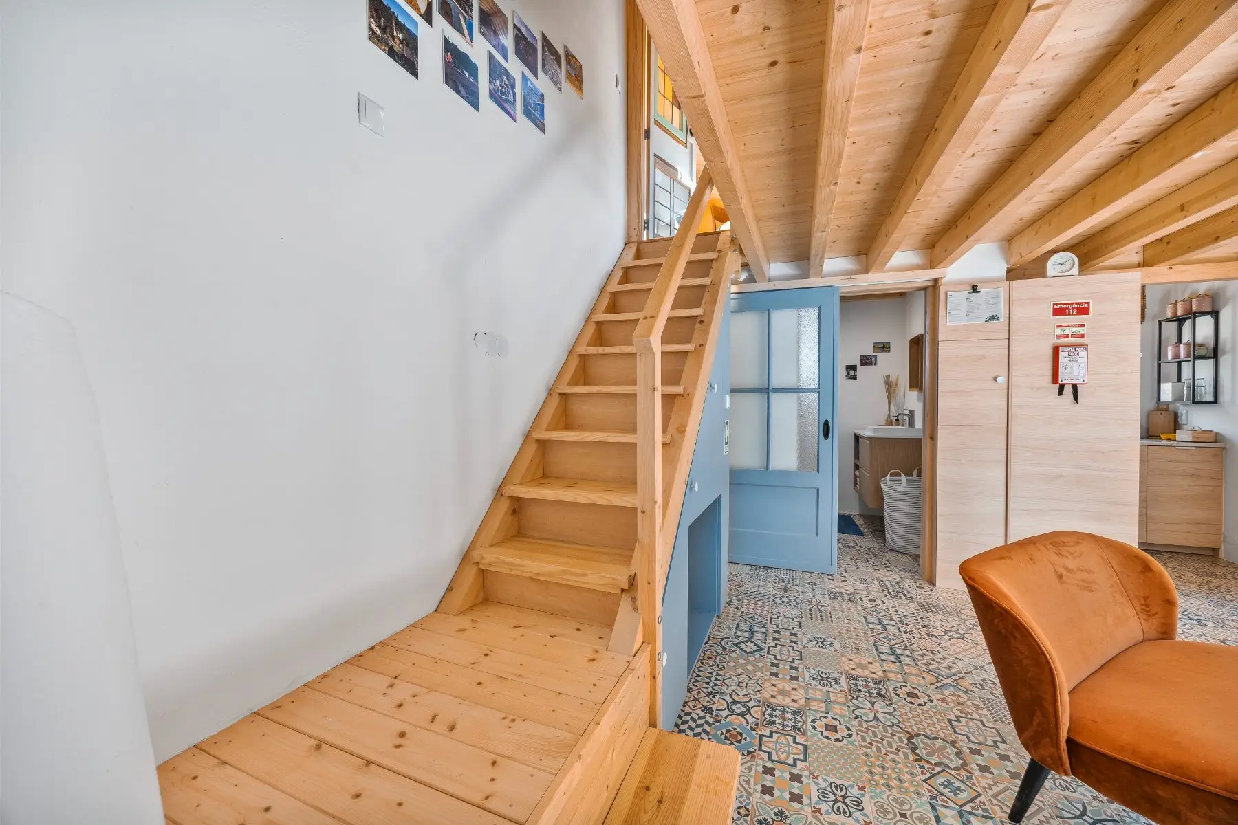 The wooden stairs up to the bedroom, history on the wall.